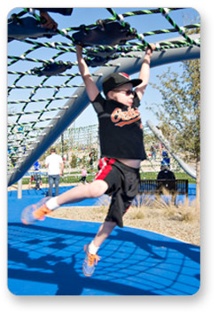 Boy swinging from bottom of Riverview Ropes Course
