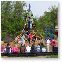 Teacher Supervising Children on Net Climber